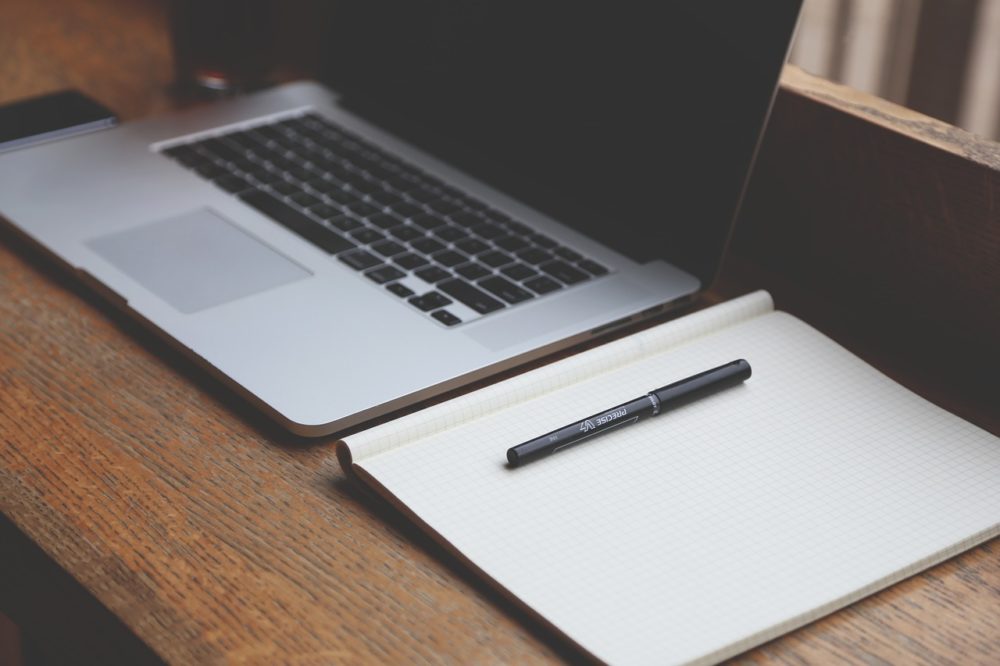 Computer and notebook on desk