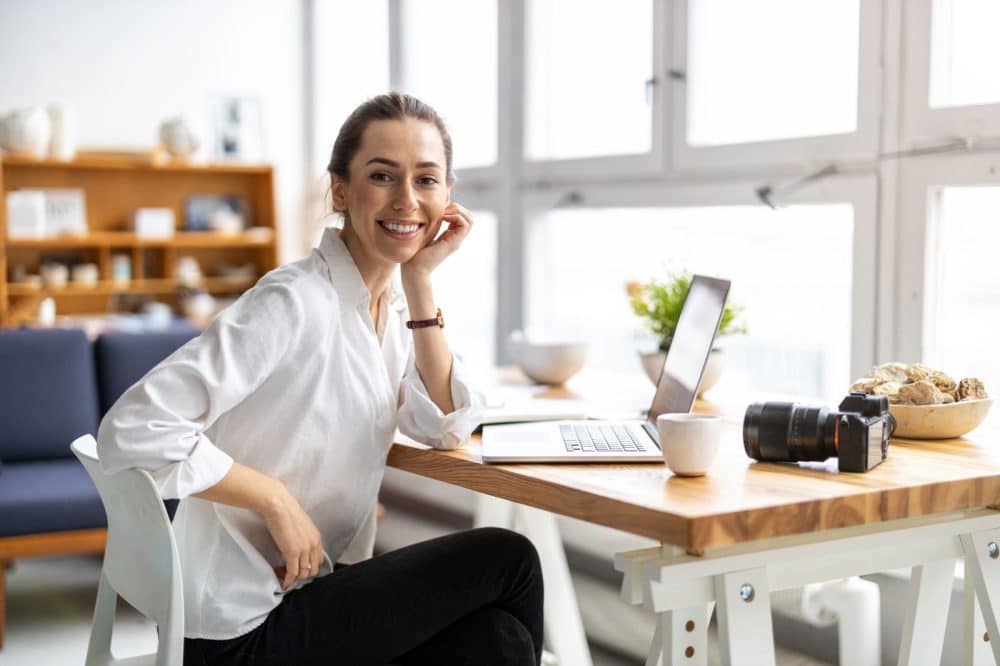 Smiling freelancer who obtained commercial property insurance