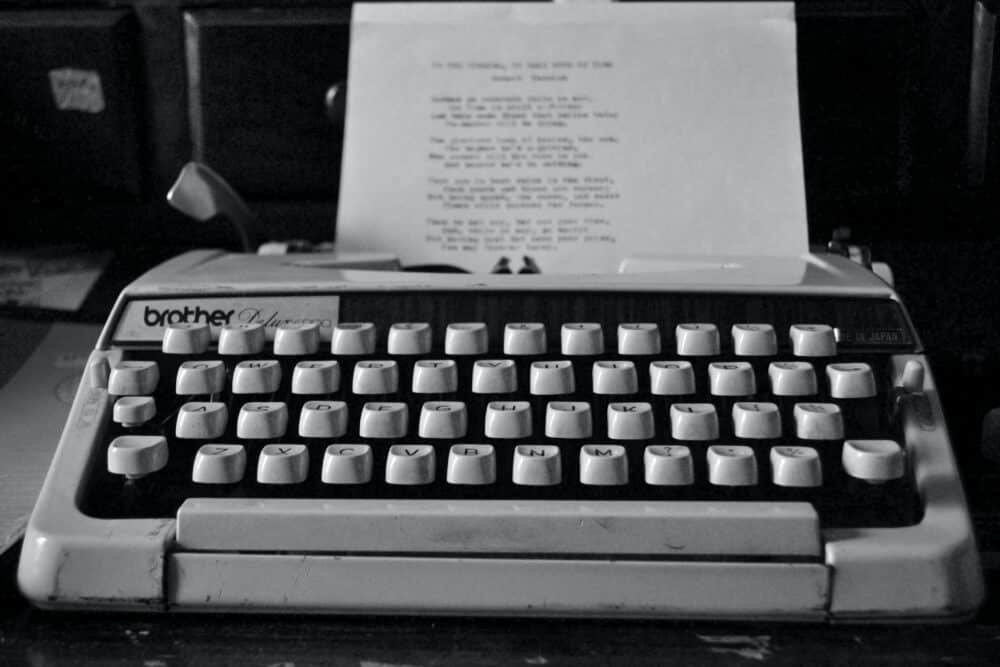 Freelance writer typing on typewriter
