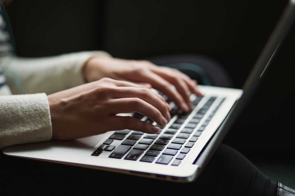 Freelance writer typing on laptop
